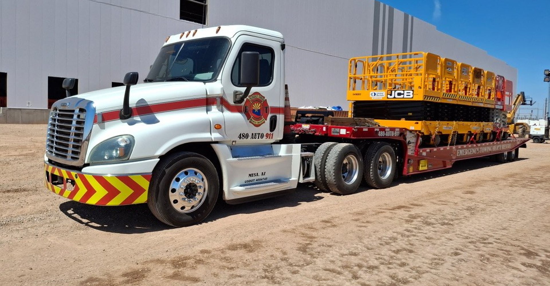 Landoll trailer hauling JCB scissor lifts for a commercial job