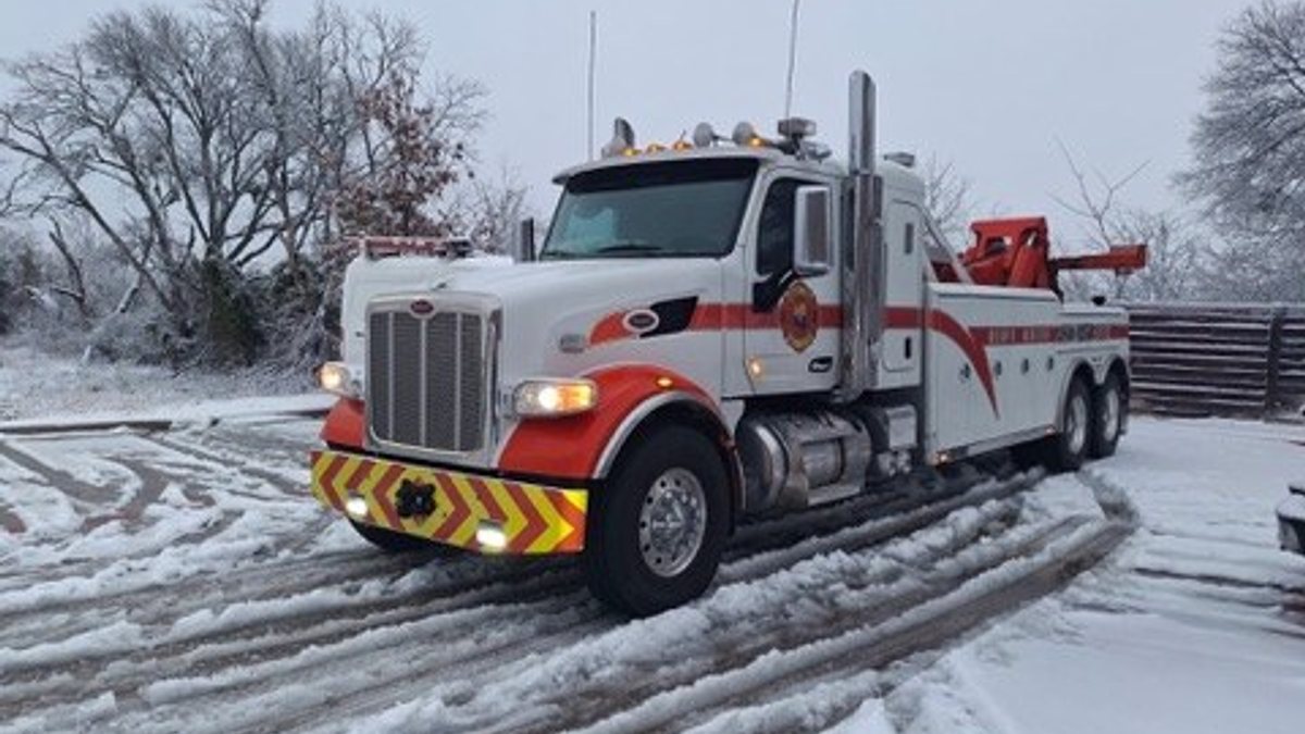 Heavy tow truck operating in Arizona high-country snow
